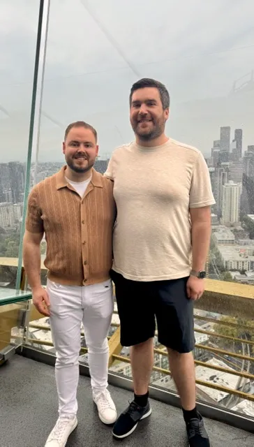 Zack and Mason at the Space Needle with the Seattle skyline behind them.